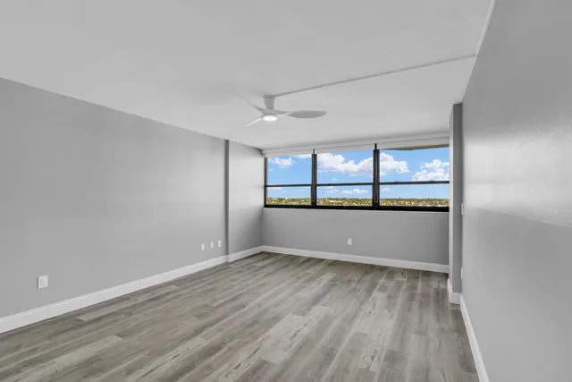 wooden floor in an empty room with a window
