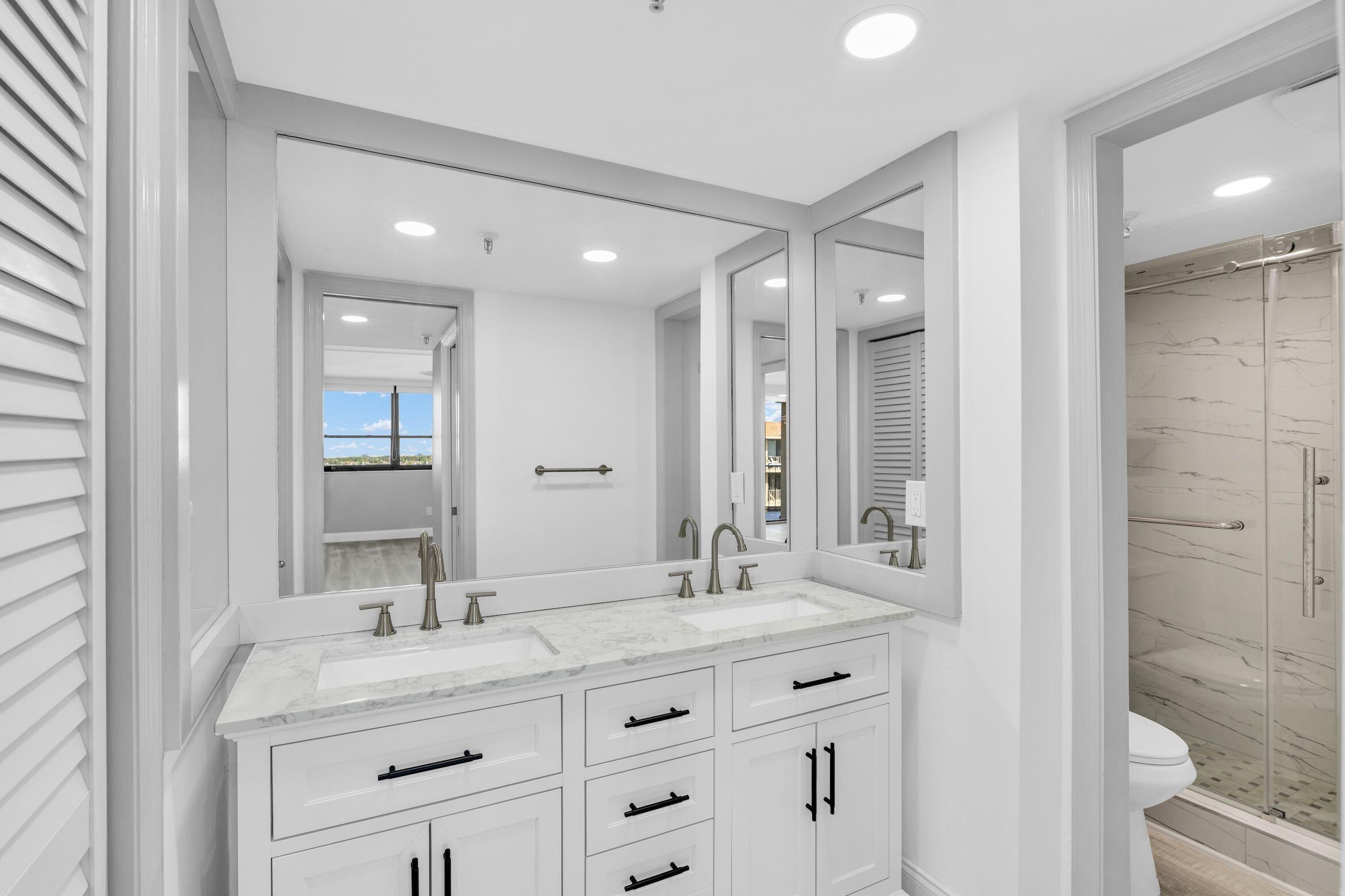 859 Jeffery Street, Unit 810 Boca Raton, FL 33487 - Photo 17 of 61 a bathroom with a granite countertop sink mirror and double