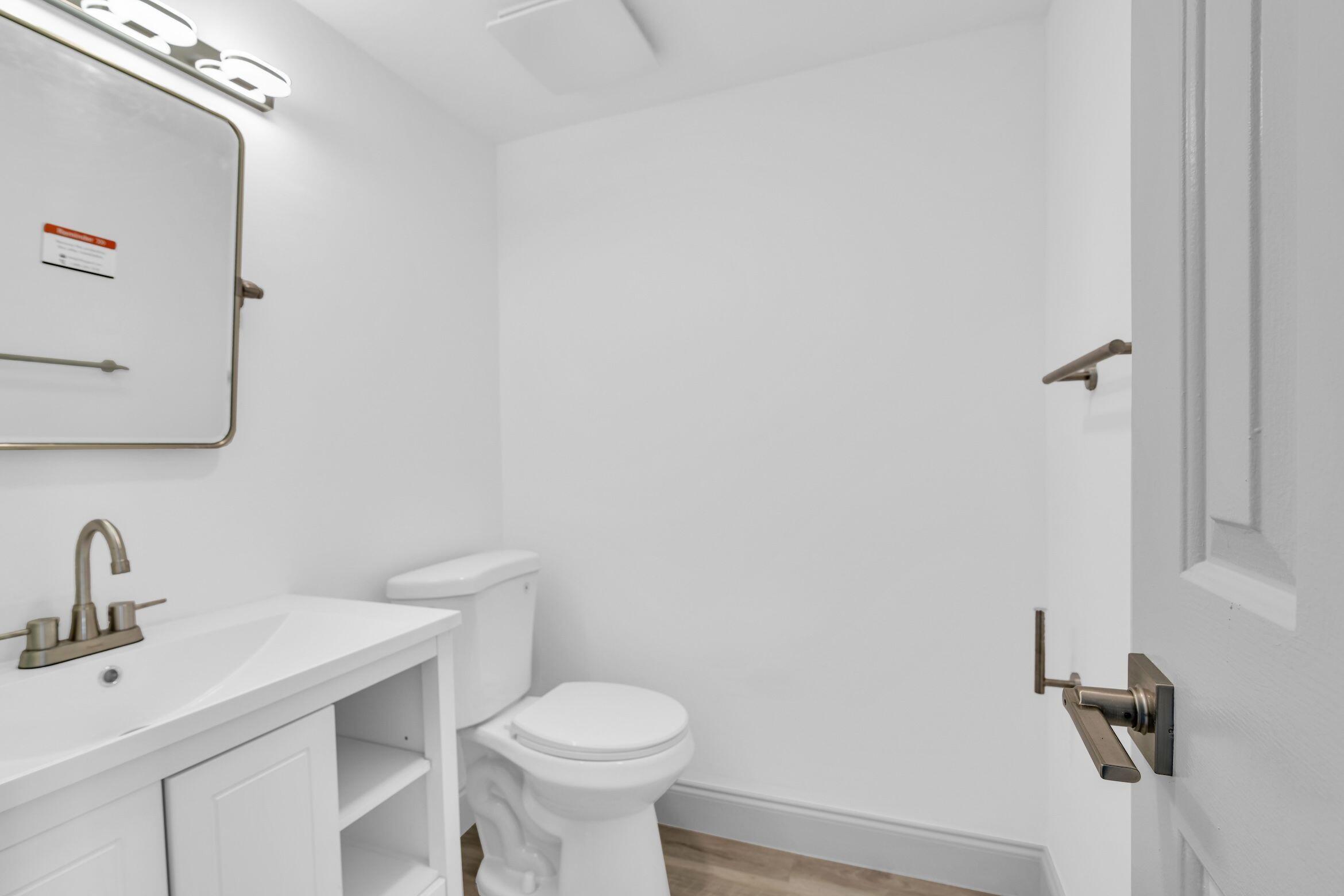 859 Jeffery Street, Unit 810 Boca Raton, FL 33487 - Photo 19 of 61 a bathroom with a sink mirror and toilet