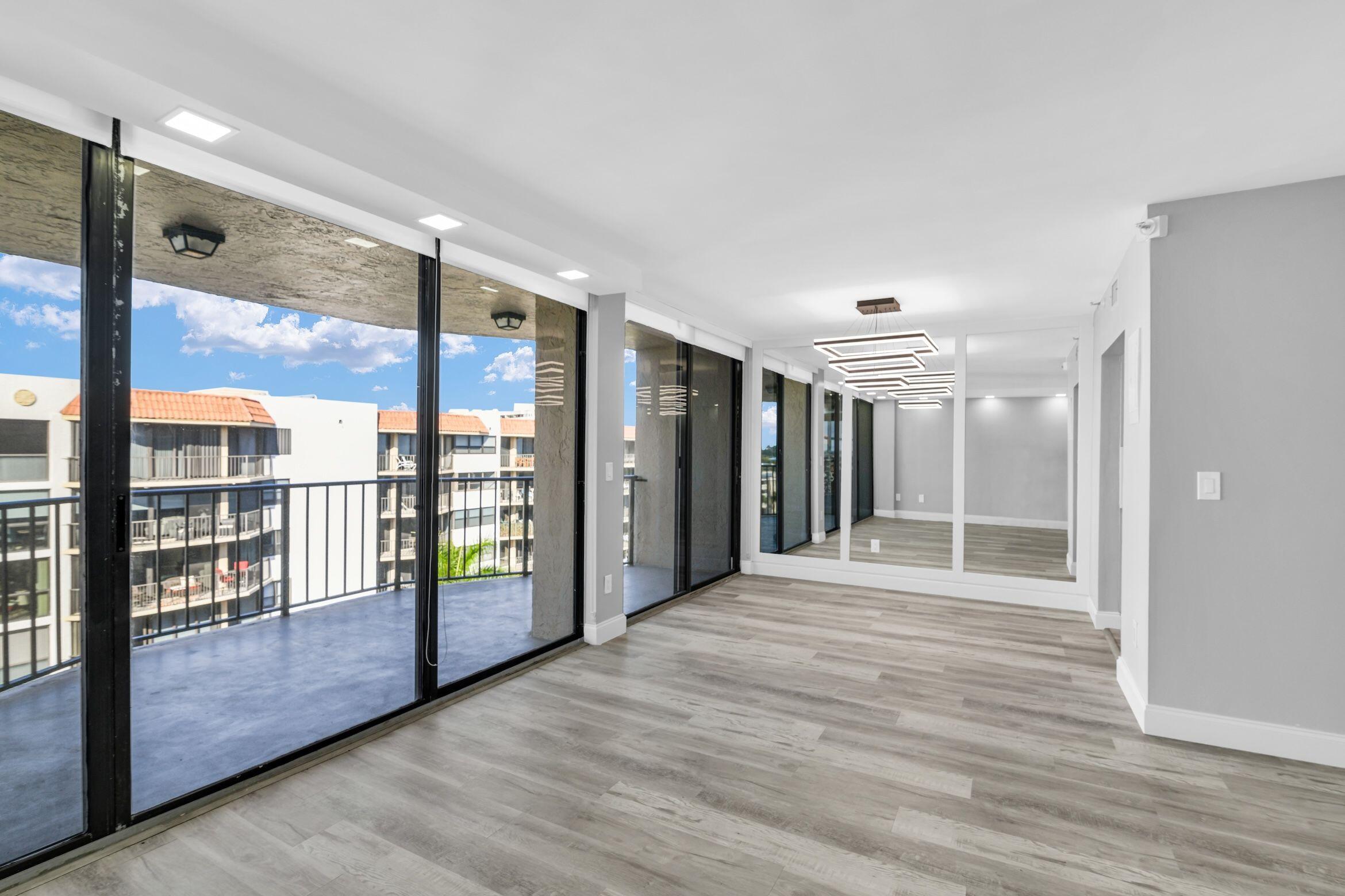859 Jeffery Street, Unit 810 Boca Raton, FL 33487 - Photo 4 of 61 a view of an empty room with glass door and windows