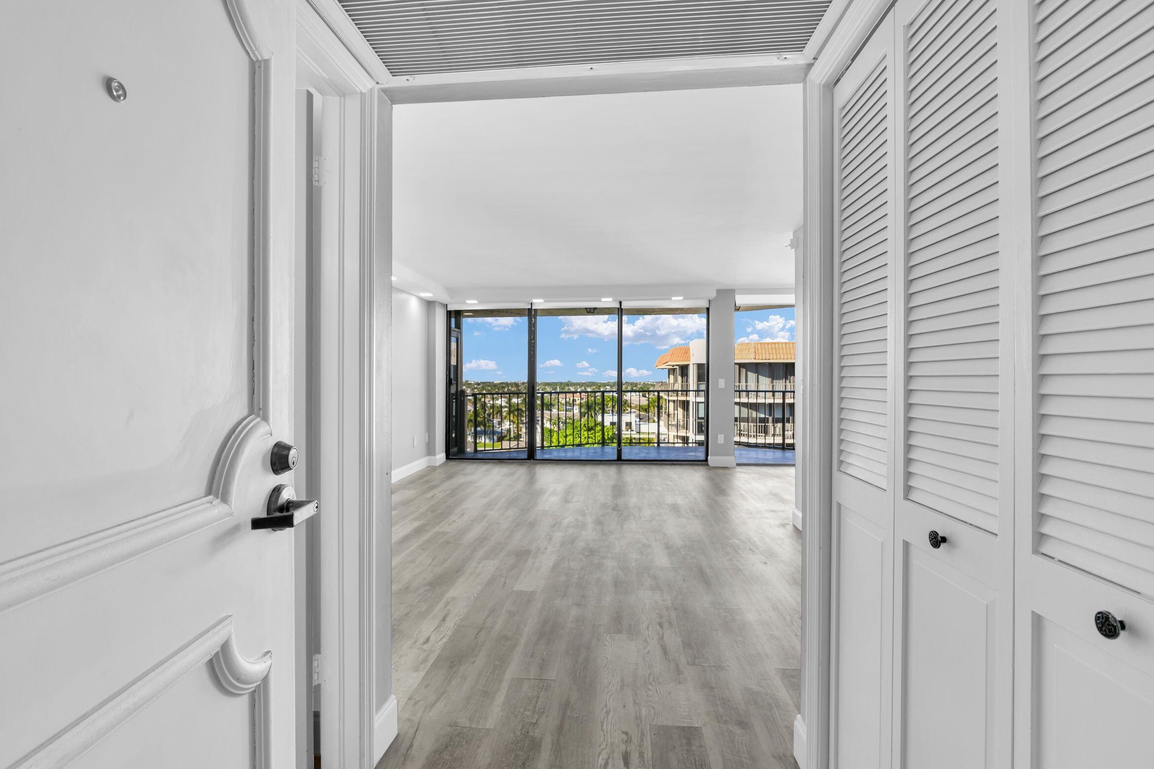 859 Jeffery Street, Unit 810 Boca Raton, FL 33487 - Photo 8 of 61 a view of a hallway with wooden floor and windows