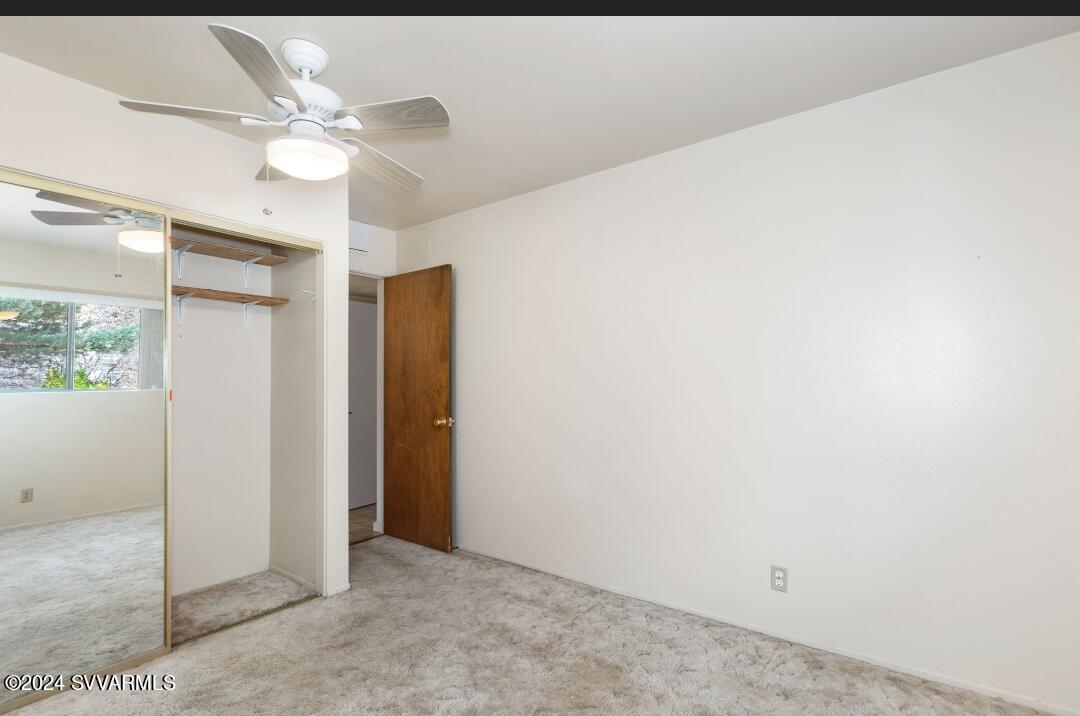 3600 East Rimrock Drive Rimrock, AZ 86335 - Photo 43 of 57 an empty room with a chandelier fan and closet