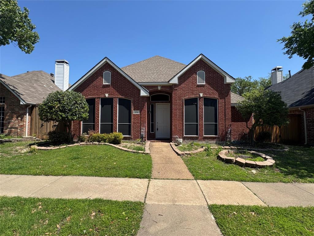2718 Creekmere Drive Richardson, TX 75082 - Photo 1 of 1 View of front of home with brick siding, a front yard, and a shingled roof