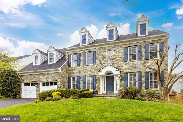 a front view of a brick house with a yard