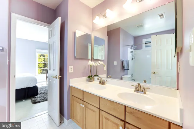 a bedroom with a bed a couch and a window