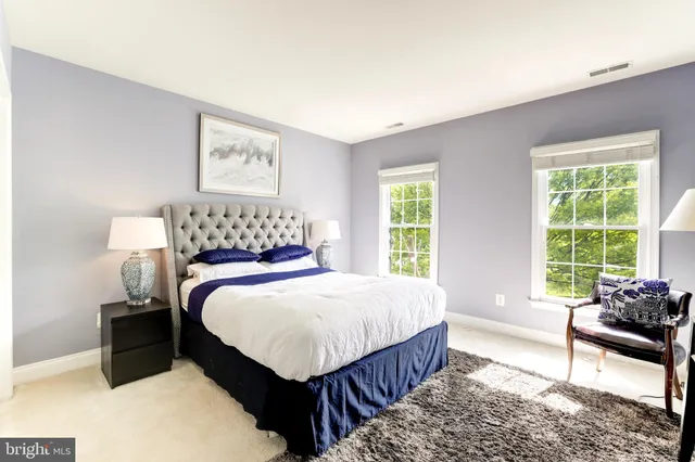 a bedroom with a bed and a night stand