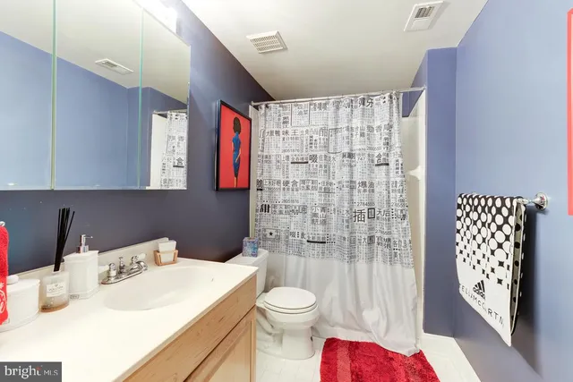 a view of a house with wooden deck and furniture