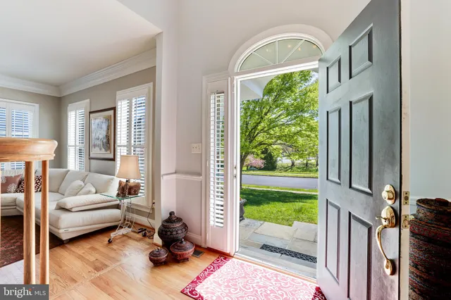 a living room with a fireplace furniture and a large window