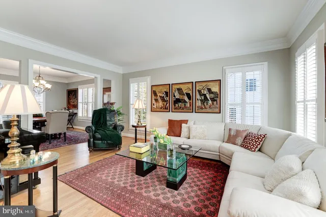 a living room with furniture wooden floor and a large window