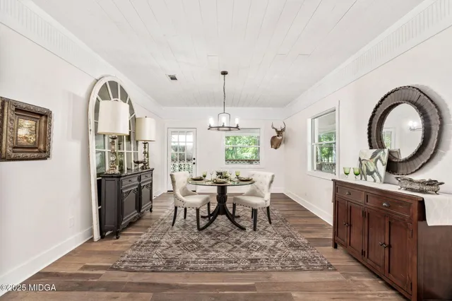 a view of a dining room with furniture window and wooden floor