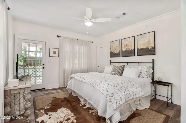 a bedroom with a large bed and a window