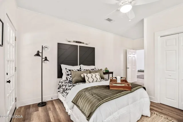 a bedroom with a bed and a chandelier