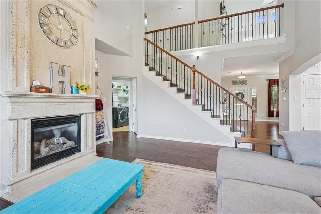 868 Valley Ridge Road Burleson, TX 76028 - Photo 17 of 39 a living room with a fireplace and a wooden floor