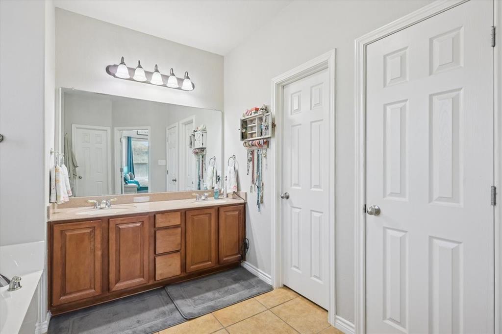 868 Valley Ridge Road Burleson, TX 76028 - Photo 21 of 39 a spacious bathroom with a double vanity sink a mirror and a shower