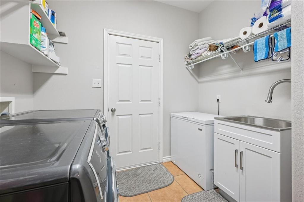 868 Valley Ridge Road Burleson, TX 76028 - Photo 24 of 39 a utility room with cabinets washer and dryer