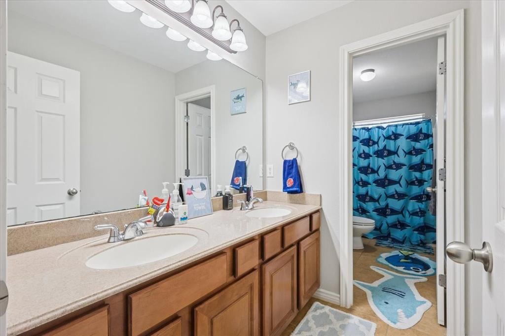 868 Valley Ridge Road Burleson, TX 76028 - Photo 25 of 39 a bathroom with a sink double vanity and a mirror