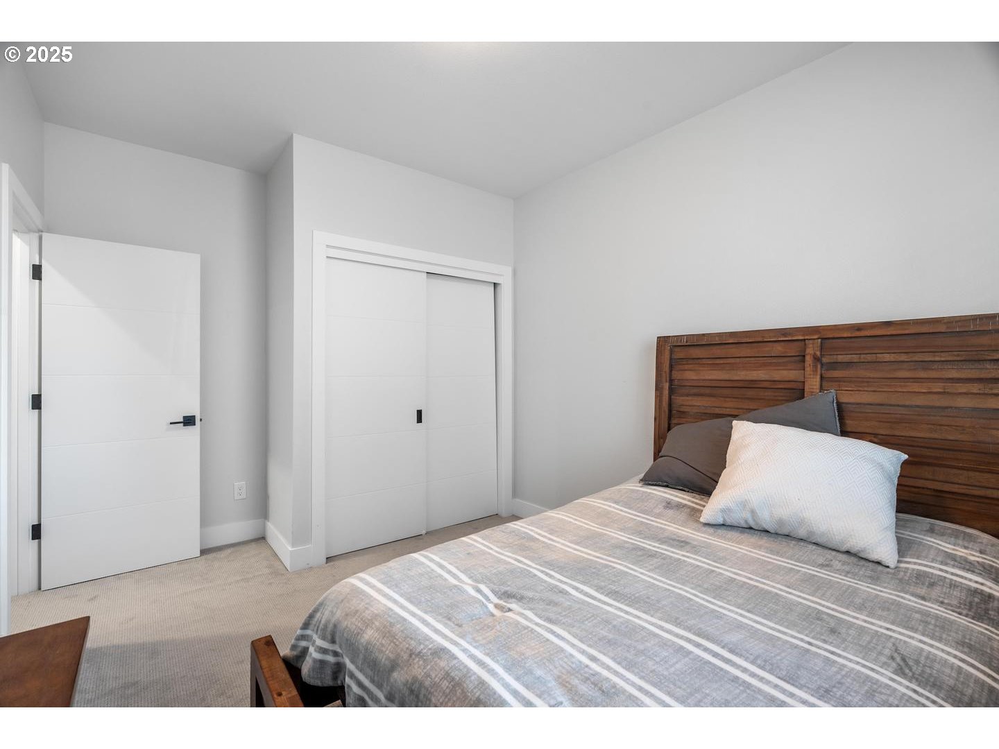 5424 Southeast Knapp Street Portland, OR 97206 - Photo 22 of 35 a bedroom with a bed and a night stand