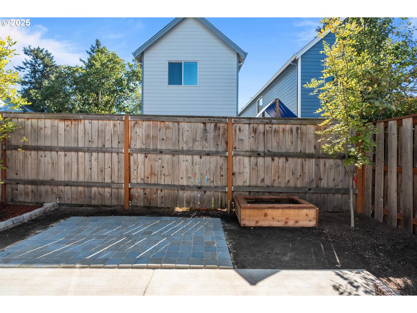 5424 Southeast Knapp Street Portland, OR 97206 - Photo 27 of 35 a view of a backyard with a wooden fence