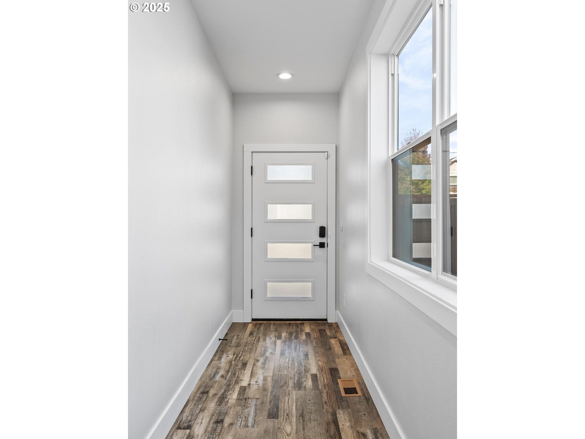 5424 Southeast Knapp Street Portland, OR 97206 - Photo 3 of 35 a view of a hallway with wooden floor and a bathroom