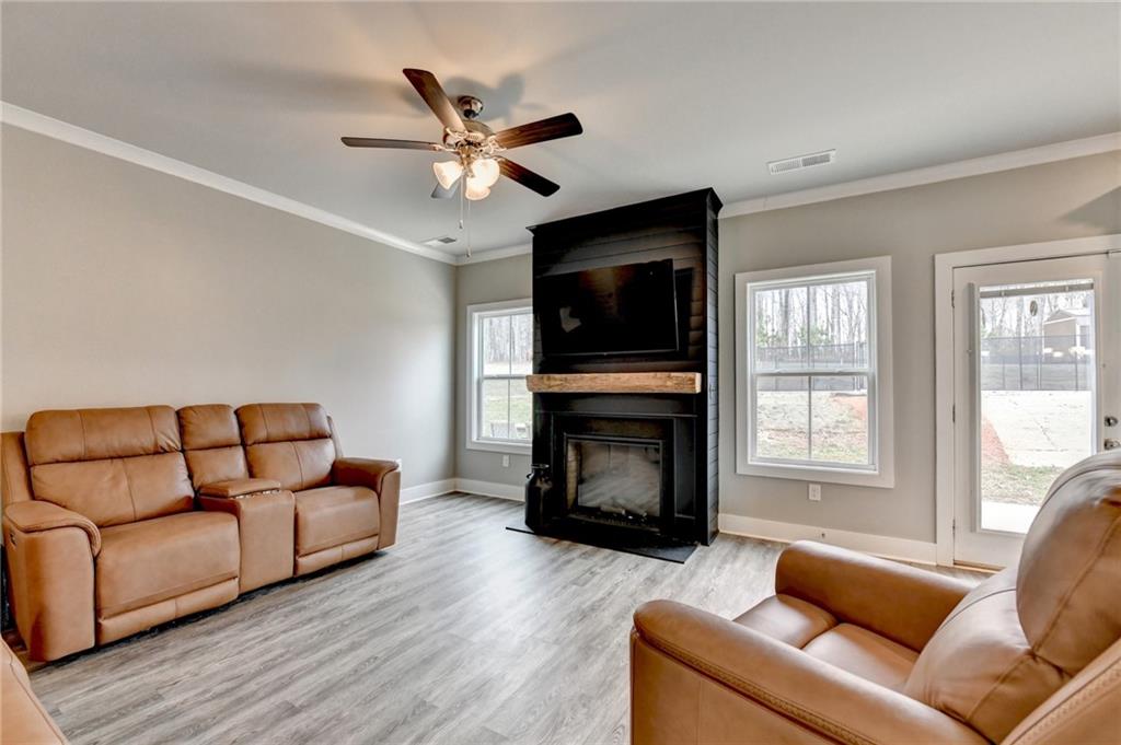 1179 Simmons Road Social Circle, GA 30025 - Photo 20 of 71 a living room with furniture a flat screen tv and a fireplace
