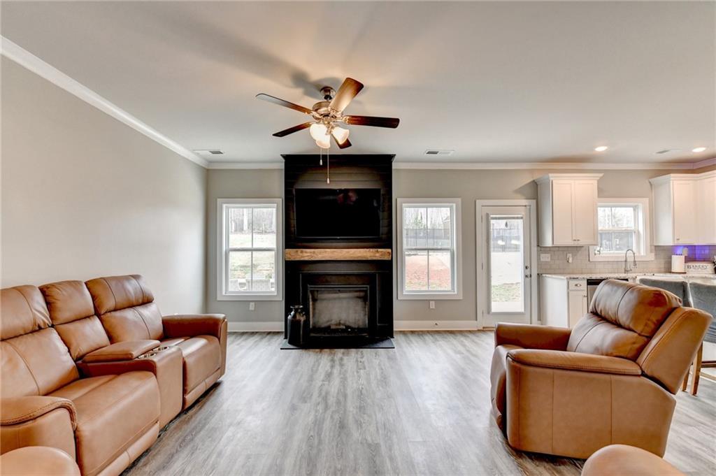 1179 Simmons Road Social Circle, GA 30025 - Photo 21 of 71 a living room with furniture fireplace and flat screen tv