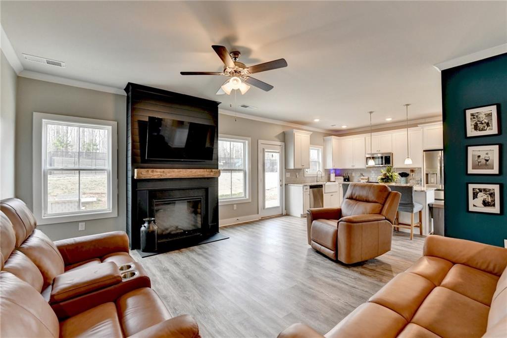 1179 Simmons Road Social Circle, GA 30025 - Photo 22 of 71 a living room with furniture a fireplace and a flat screen tv