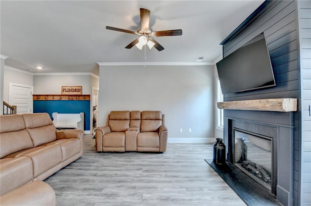 1179 Simmons Road Social Circle, GA 30025 - Photo 25 of 71 a living room with furniture and a flat screen tv