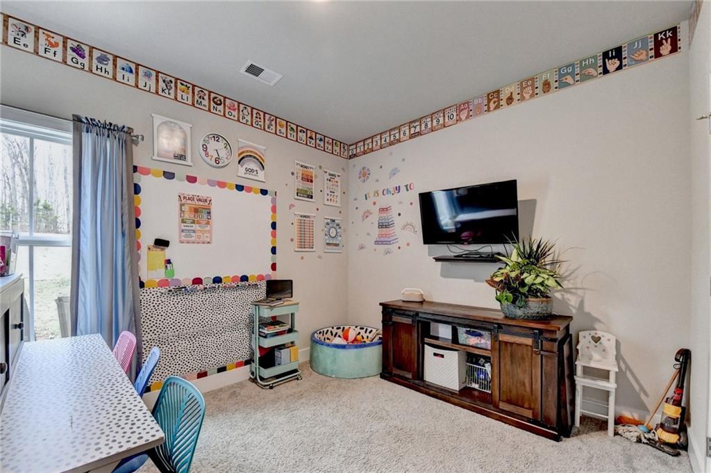 1179 Simmons Road Social Circle, GA 30025 - Photo 29 of 71 a living room with furniture and a flat screen tv