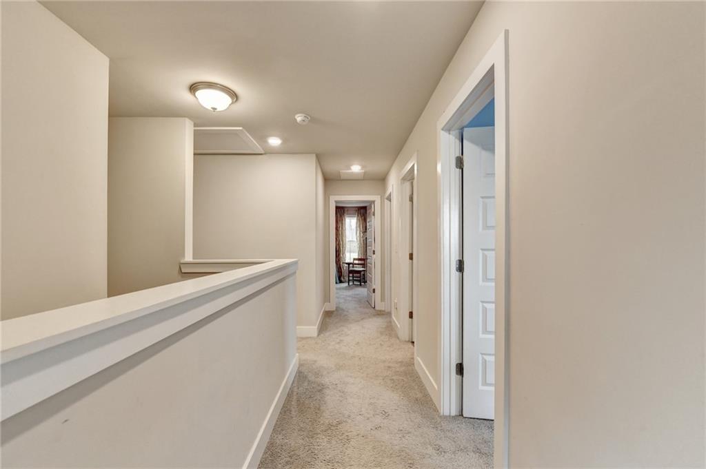 1179 Simmons Road Social Circle, GA 30025 - Photo 31 of 71 a view of a hallway with wooden floor and staircase