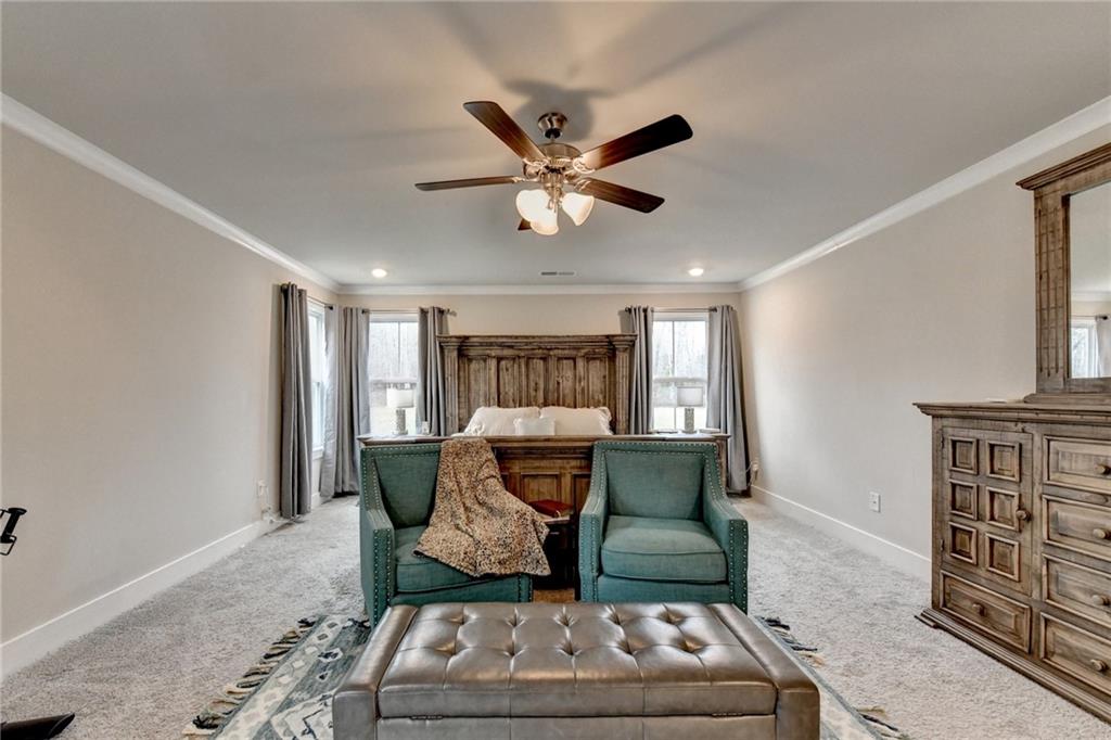 1179 Simmons Road Social Circle, GA 30025 - Photo 34 of 71 a living room with furniture and a ceiling fan