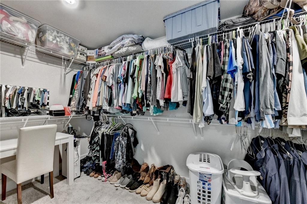 1179 Simmons Road Social Circle, GA 30025 - Photo 42 of 71 a view of walk in closet with clothes and shoes