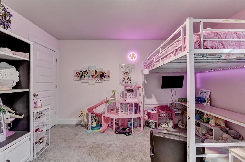 1179 Simmons Road Social Circle, GA 30025 - Photo 44 of 71 a living room with furniture and a flat screen tv