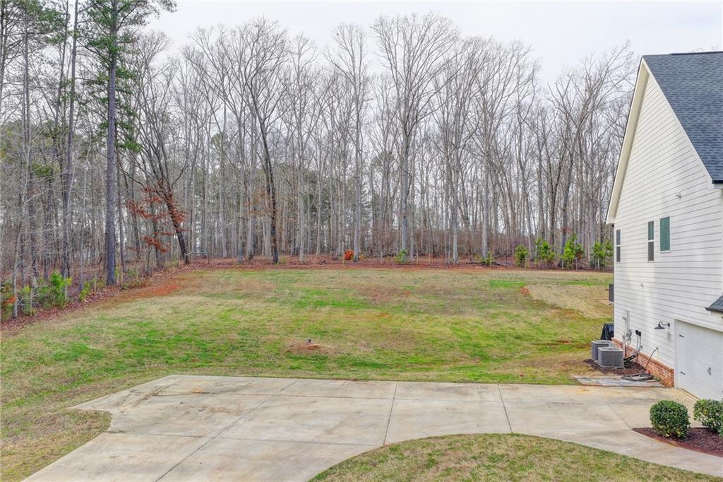 1179 Simmons Road Social Circle, GA 30025 - Photo 54 of 71 a view of a yard with large trees