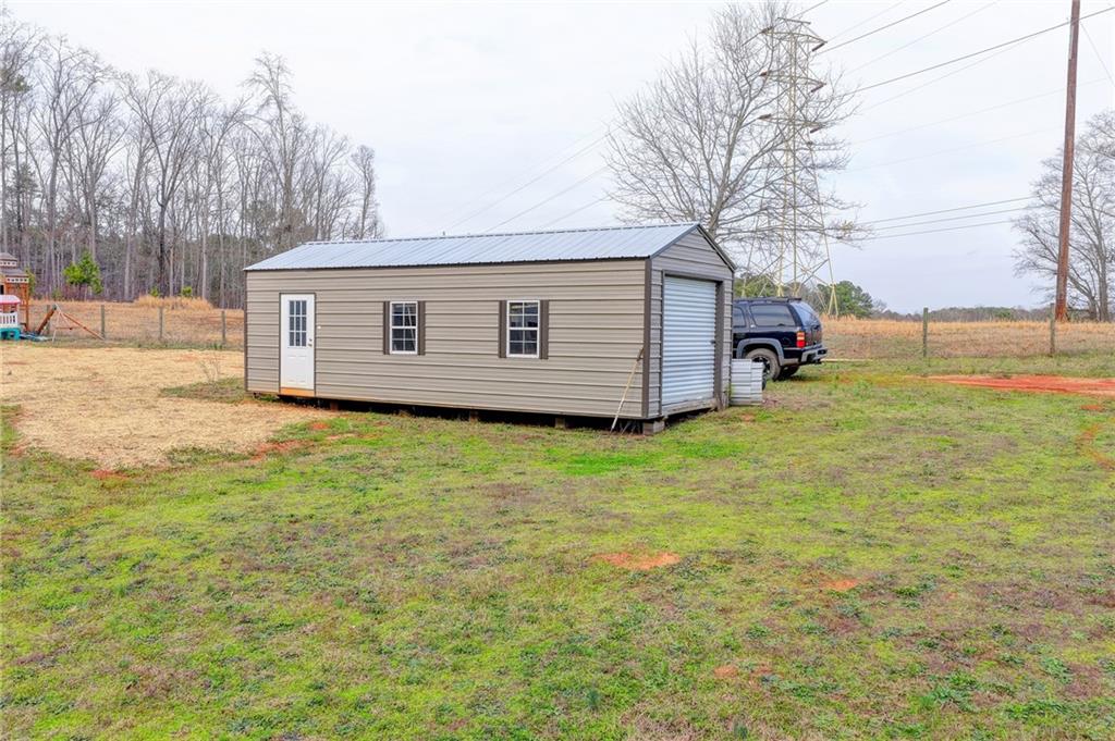 1179 Simmons Road Social Circle, GA 30025 - Photo 65 of 71 a view of a backyard with a large tree