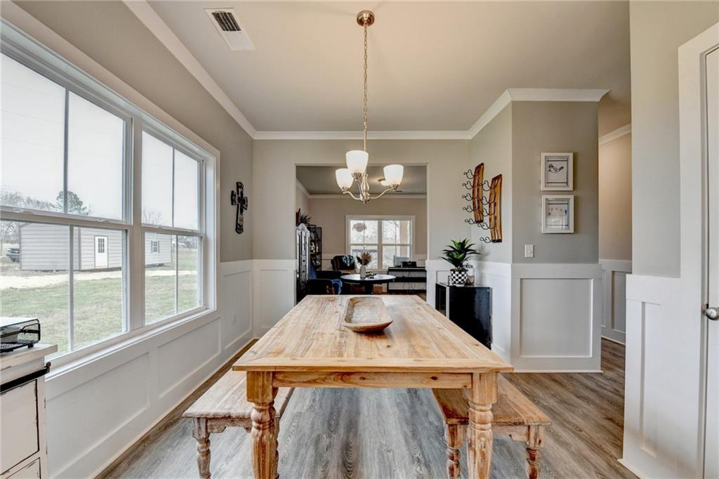 1179 Simmons Road Social Circle, GA 30025 - Photo 9 of 71 a view of a dining room with furniture window and wooden floor