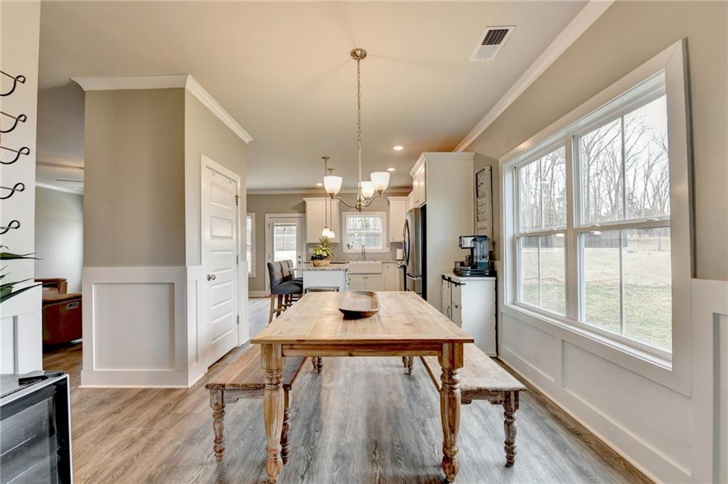 1179 Simmons Road Social Circle, GA 30025 - Photo 10 of 71 a view of a dining room with furniture window and wooden floor