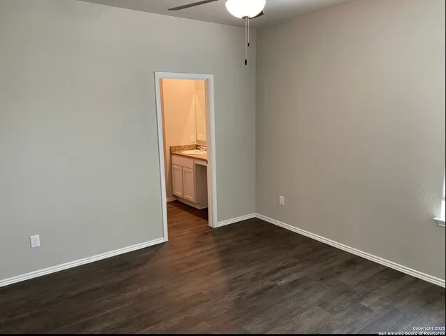 an empty room with wooden floor and closet