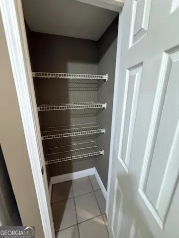 a kitchen with a sink a stove cabinets and a window