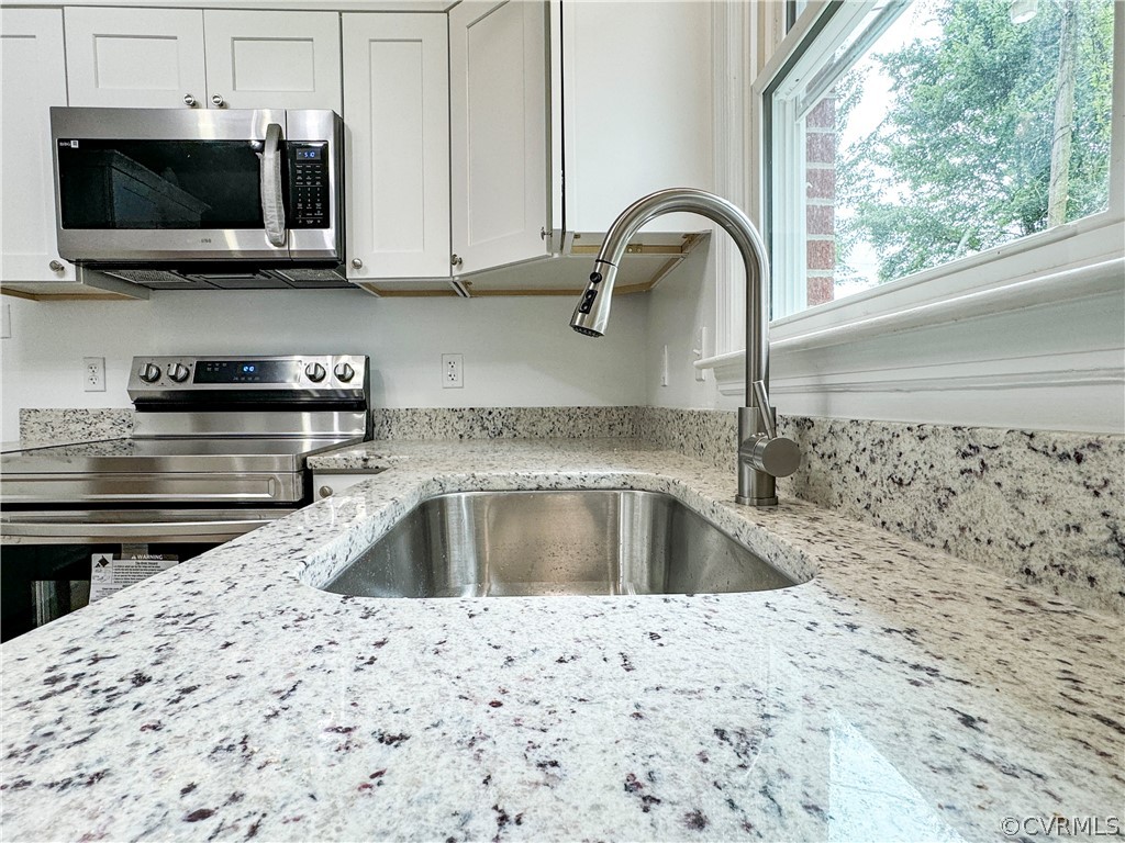 1787 Mc Cune Road Crewe, VA 23930 - Photo 11 of 41 a kitchen with granite countertop a sink and a stove top oven