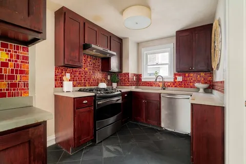 a kitchen with stainless steel appliances granite countertop a refrigerator and a stove top oven