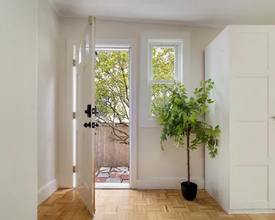 a backyard of a house with a tree