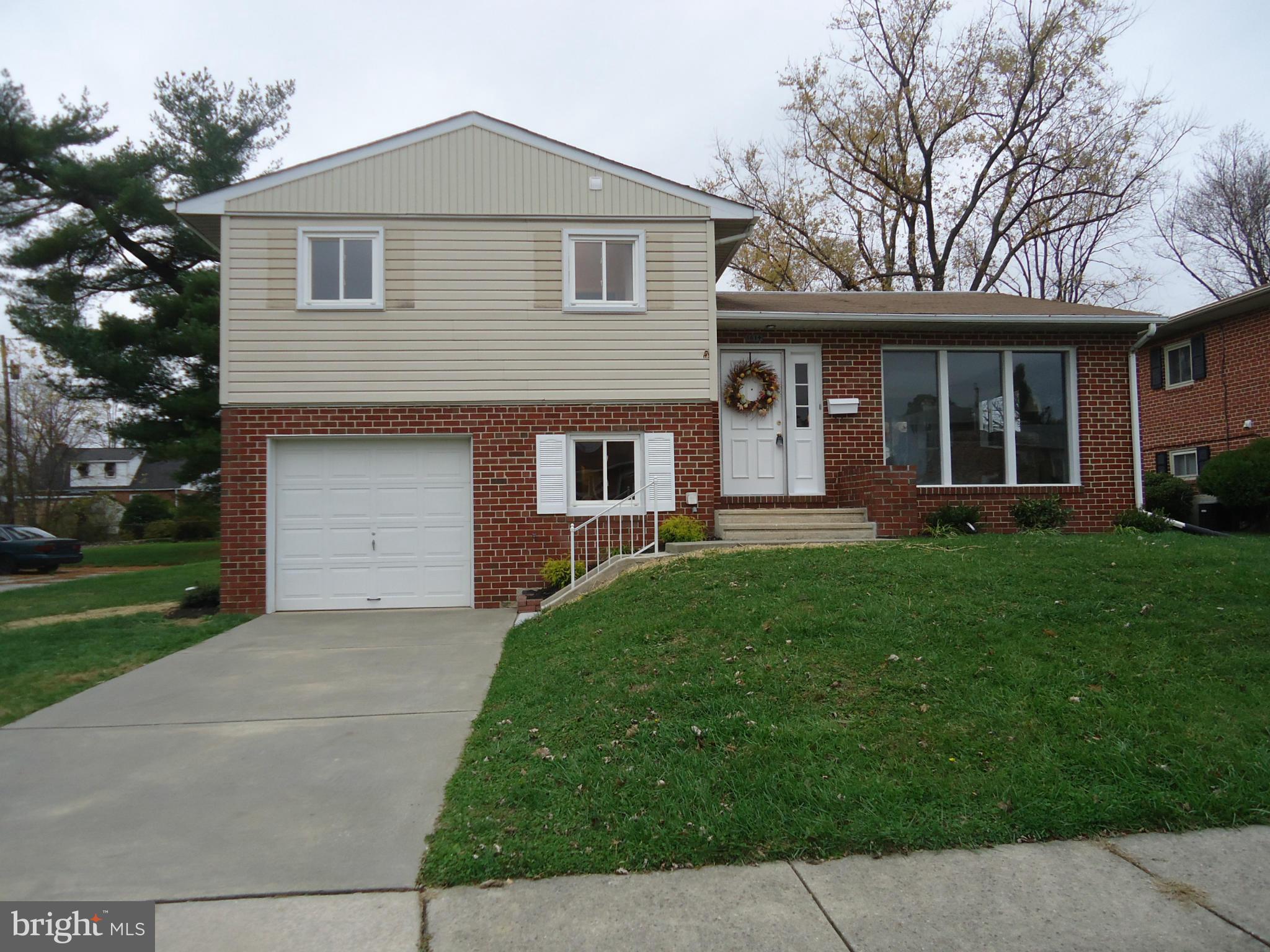 3614 Bellmore Road Baltimore, MD 21244 - Photo 1 of 20 a front view of a house with a yard and trees
