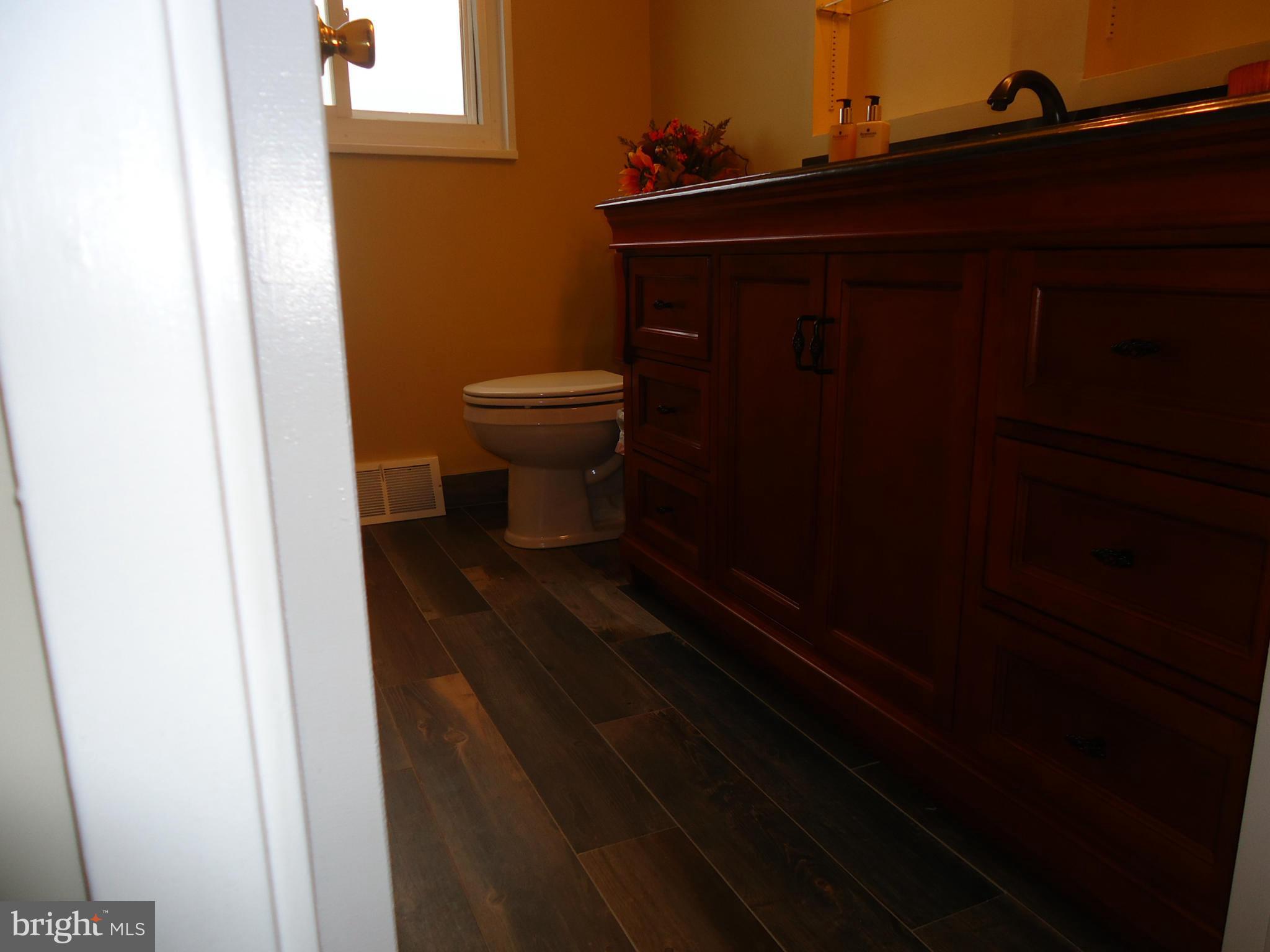 3614 Bellmore Road Baltimore, MD 21244 - Photo 12 of 20 a bathroom with a toilet and a mirror