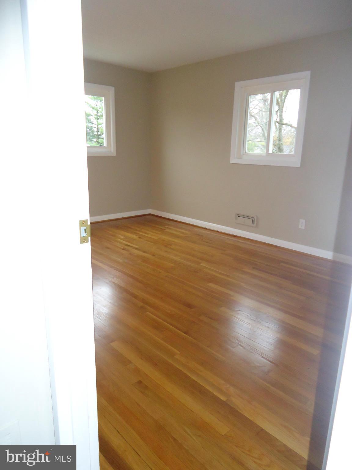 3614 Bellmore Road Baltimore, MD 21244 - Photo 13 of 20 a view of an empty room with wooden floor and a window