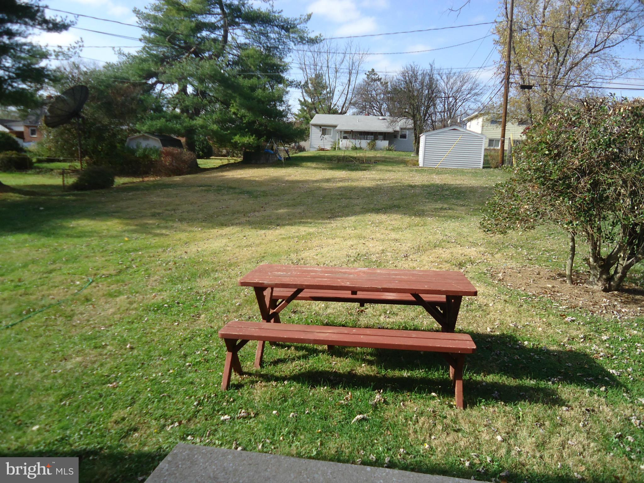 3614 Bellmore Road Baltimore, MD 21244 - Photo 19 of 20 a view of a bench in the garden near a lake