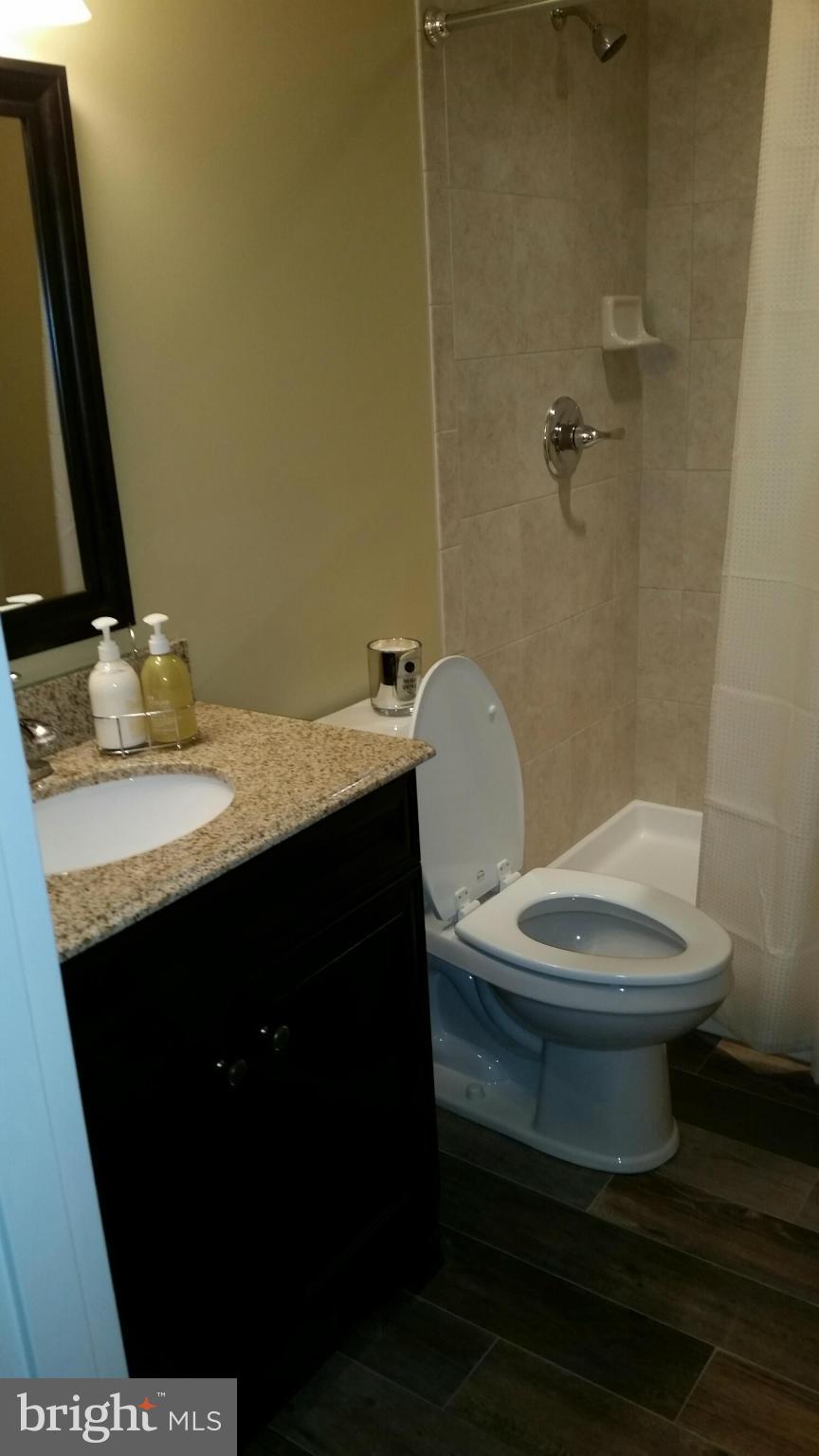 3614 Bellmore Road Baltimore, MD 21244 - Photo 20 of 20 a bathroom with a toilet a sink and mirror