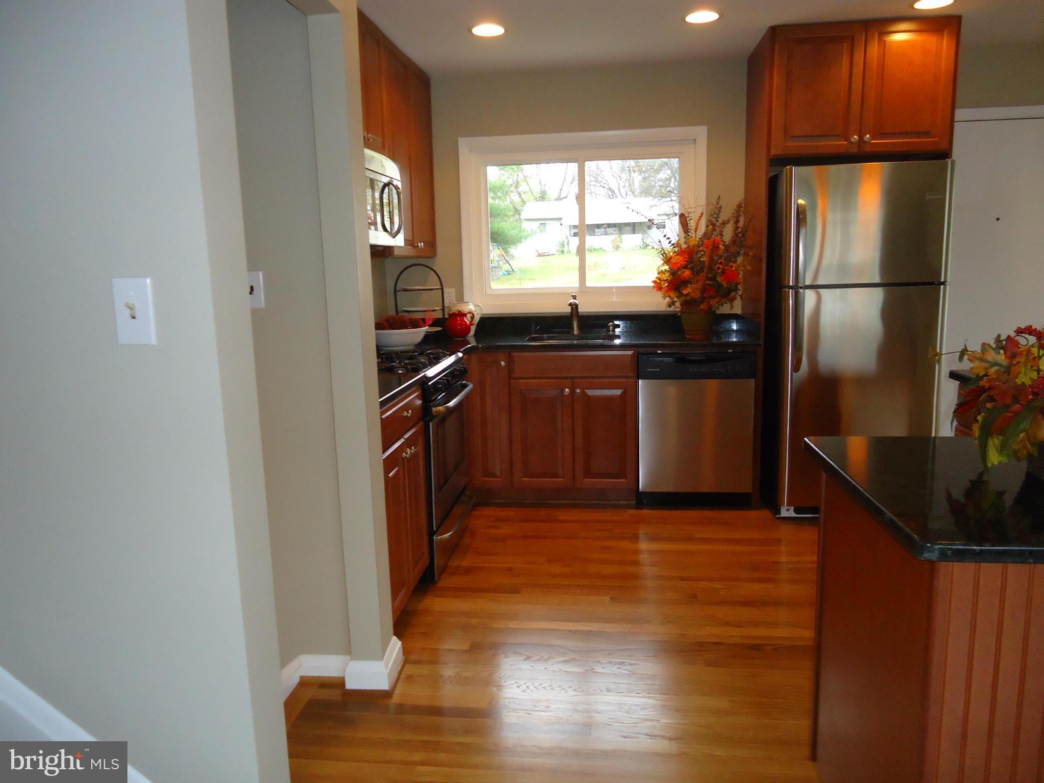 3614 Bellmore Road Baltimore, MD 21244 - Photo 8 of 20 a kitchen with granite countertop a refrigerator and a sink