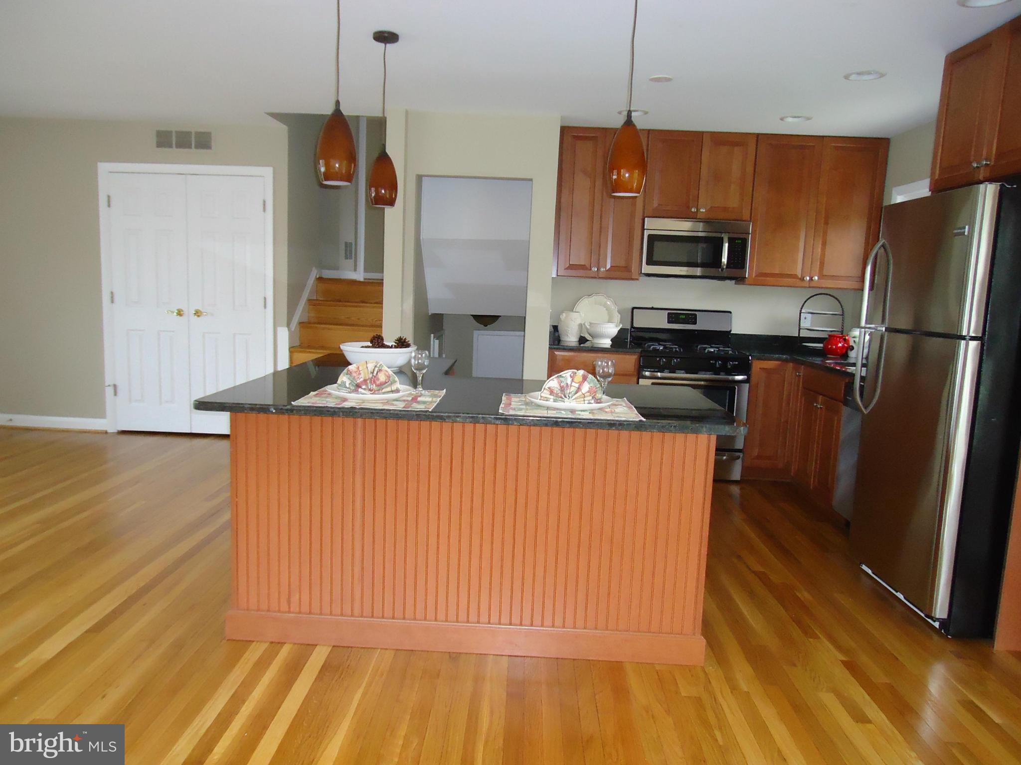 3614 Bellmore Road Baltimore, MD 21244 - Photo 9 of 20 a kitchen with stainless steel appliances granite countertop a refrigerator a stove top oven a sink and dishwasher