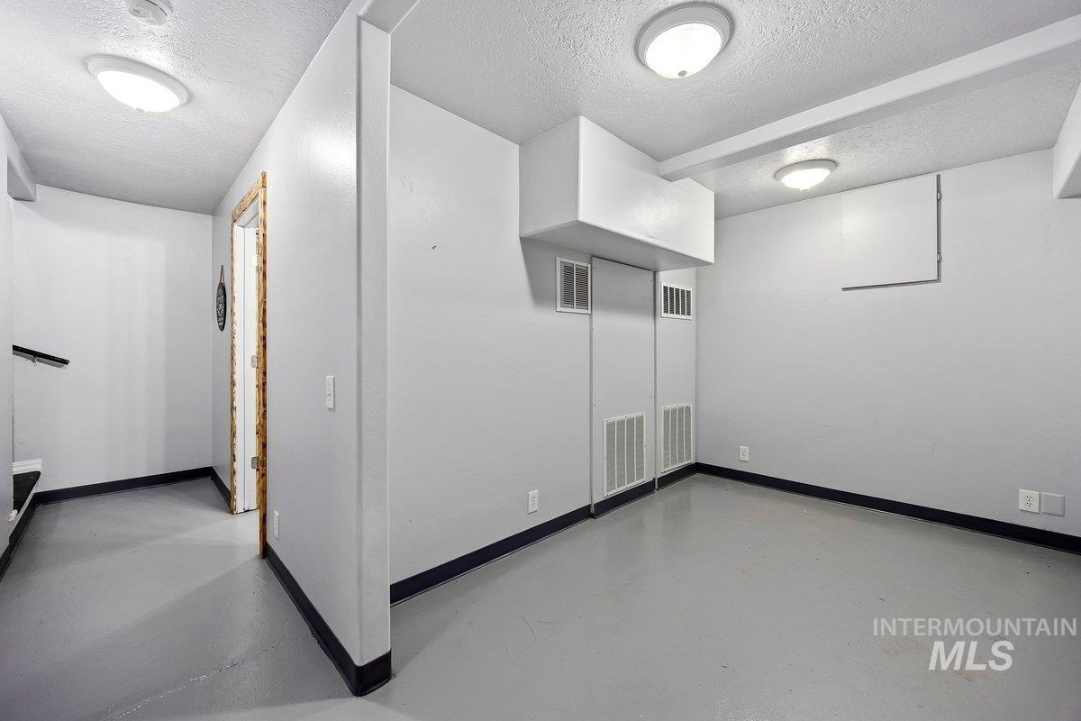418 South Date Street Shoshone, ID 83352 - Photo 21 of 36 Finished lower level room featuring recessed lighting, painted concrete flooring, and a neutral color palette