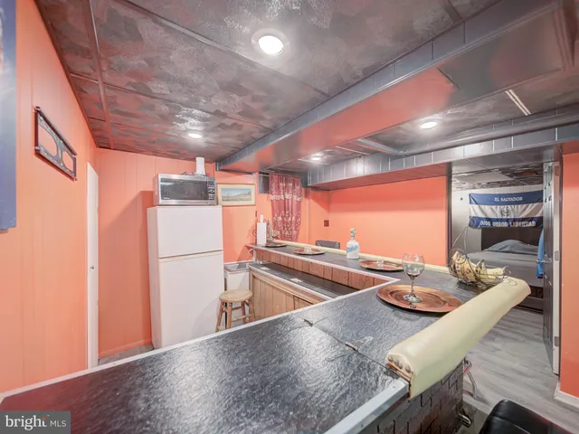 a kitchen with sink refrigerator and stove